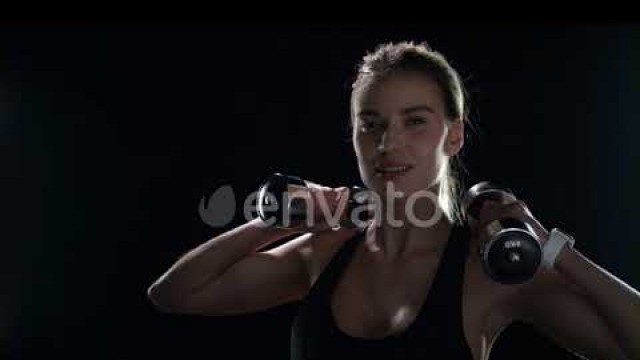 'Fitness Woman Training Dumbbell Exercise on Black Background. Sport Model | Stock Footage - Enva...'