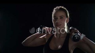 'Fitness Woman Training Dumbbell Exercise on Black Background. Sport Model | Stock Footage - Enva...'