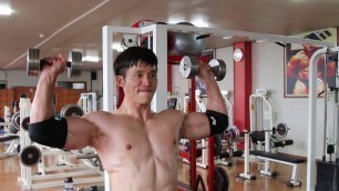 'korean gym instructor; KIM JU WAN is doing shoulder technique work out'